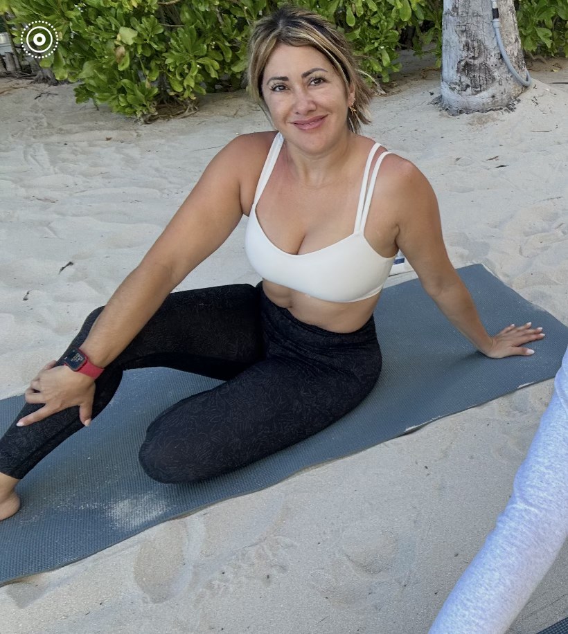 A TruFitness4Life client seated on an exercise mat outdoors