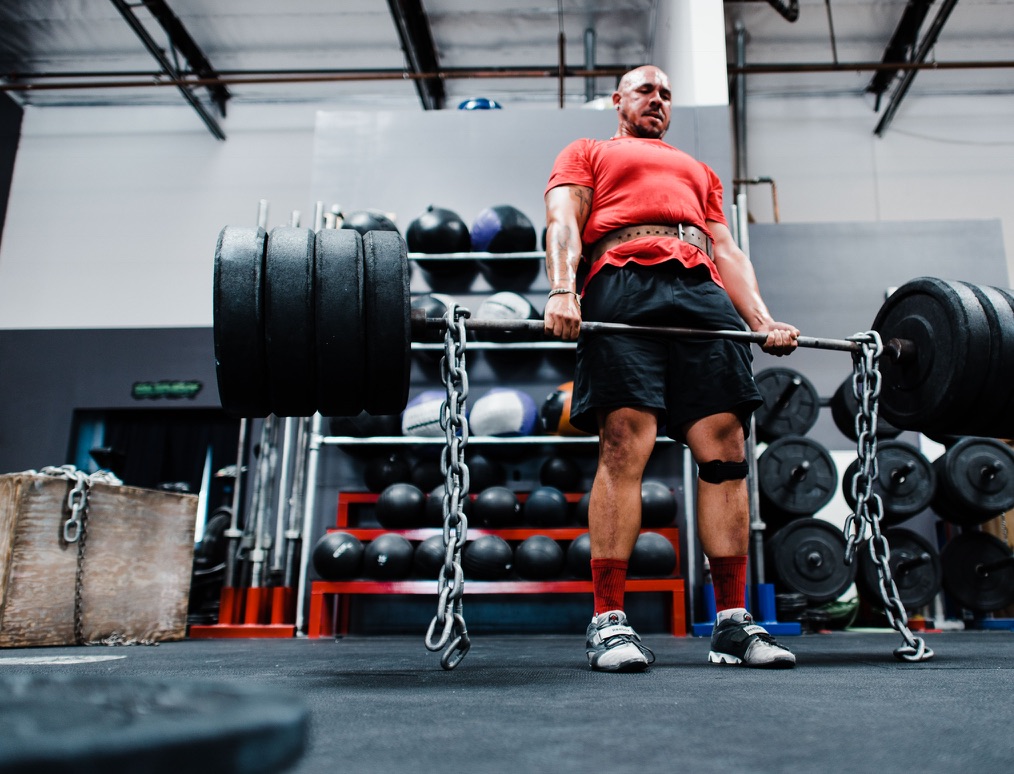 Truman lifting a heavily loaded barbell in the gym